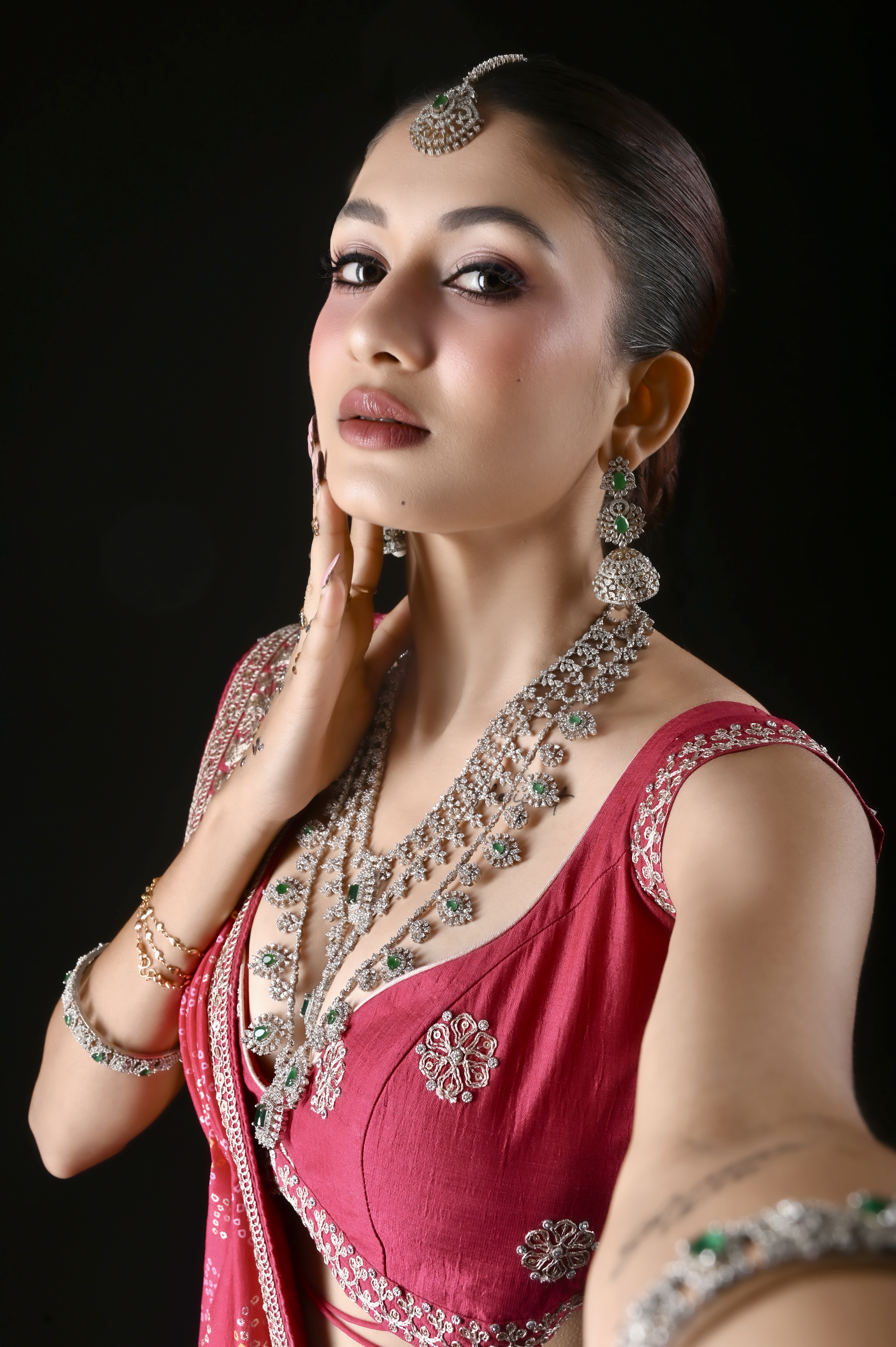 Close bridal beauty study with emerald jewellery