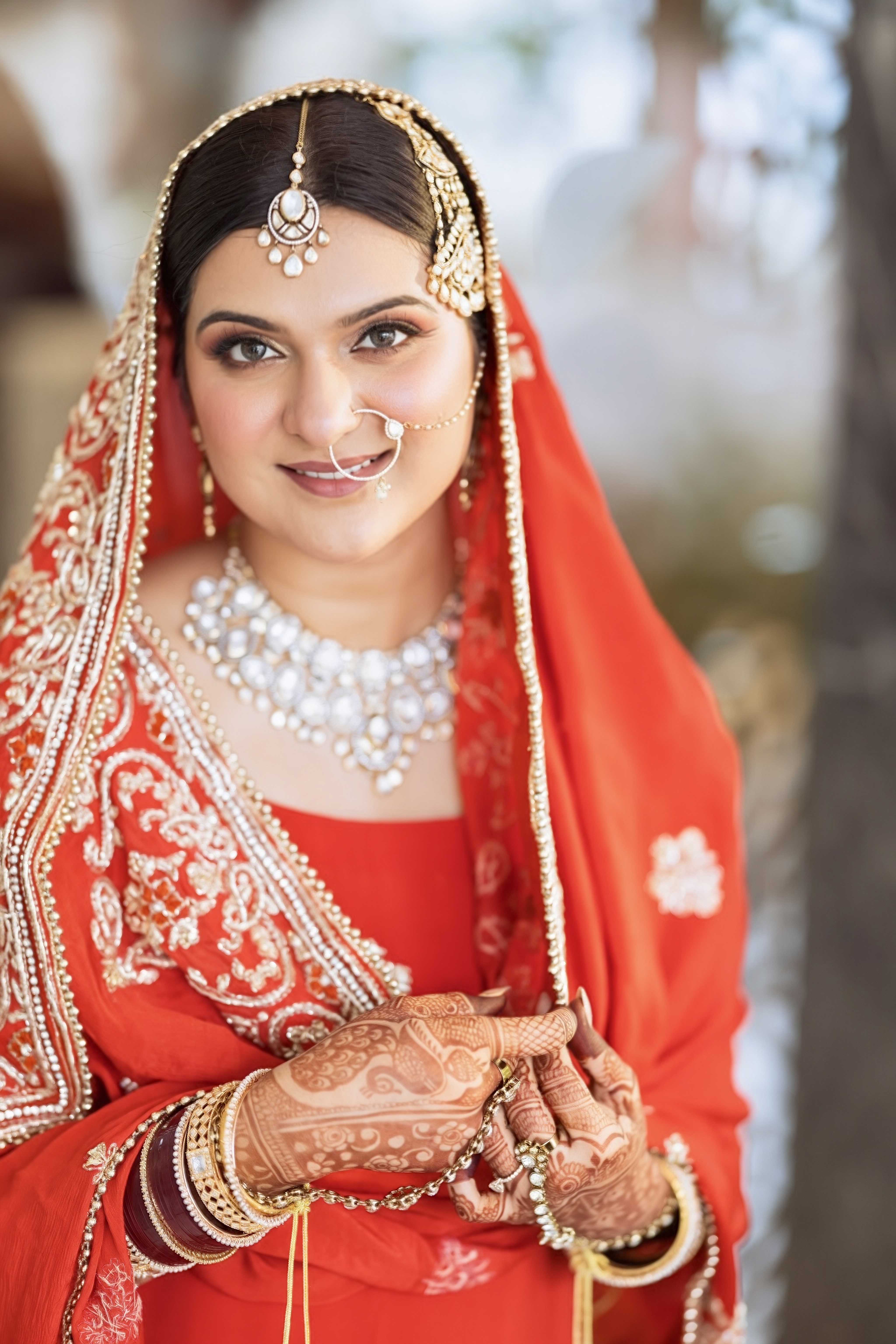 Close portrait of a bride in red wedding attire