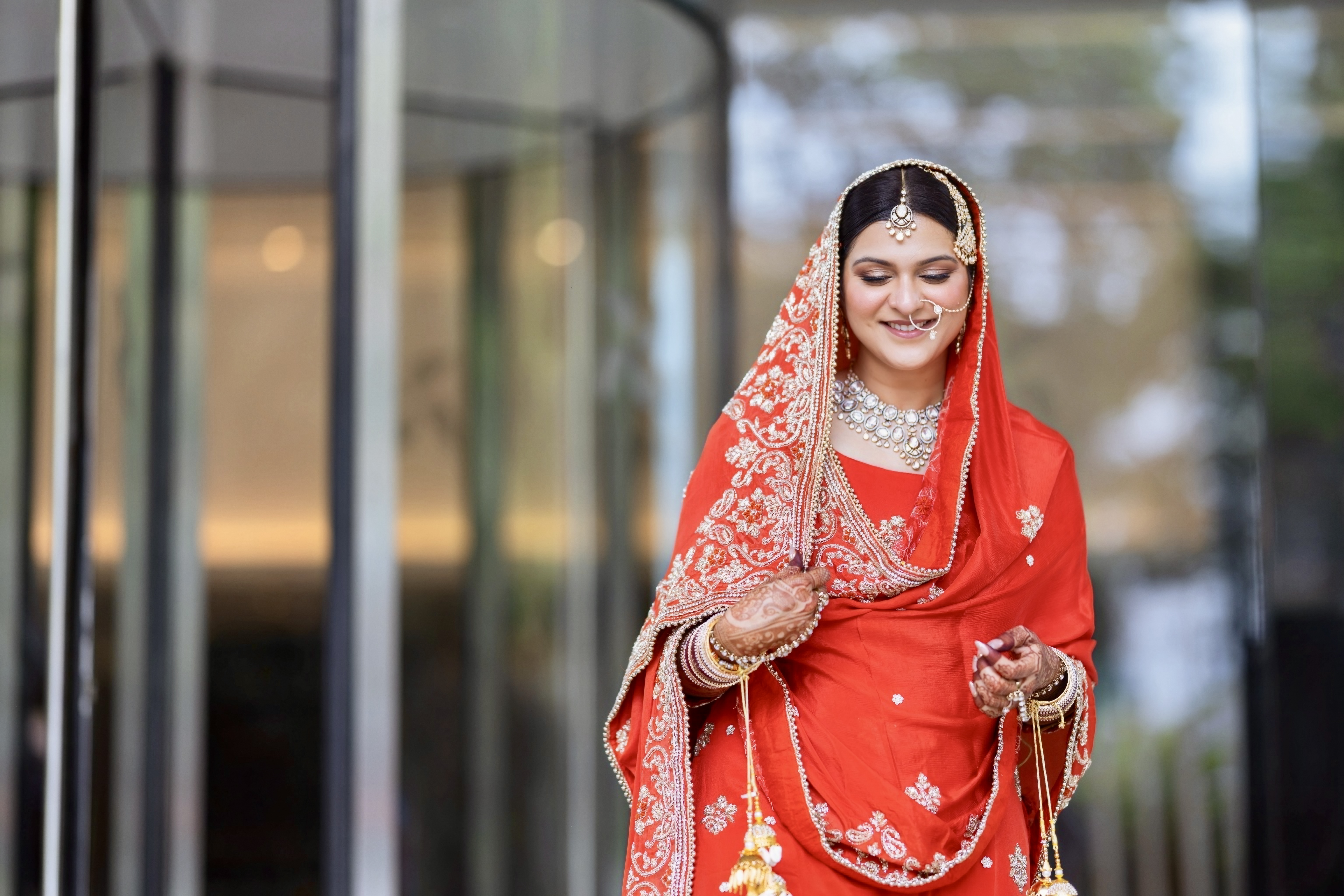 Bride in red wedding attire smiling softly