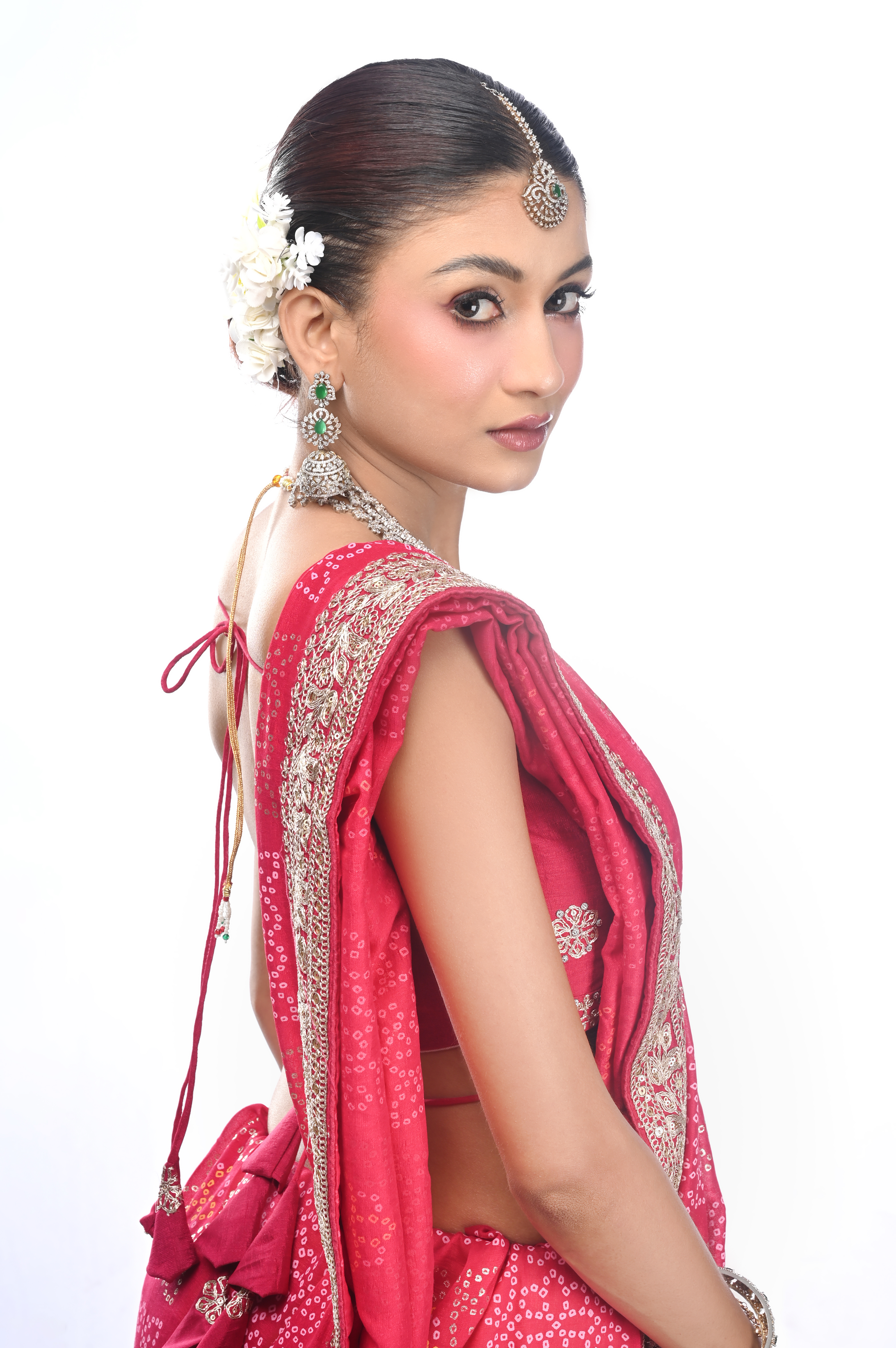 Bridal portrait in red seen in three-quarter profile against white
