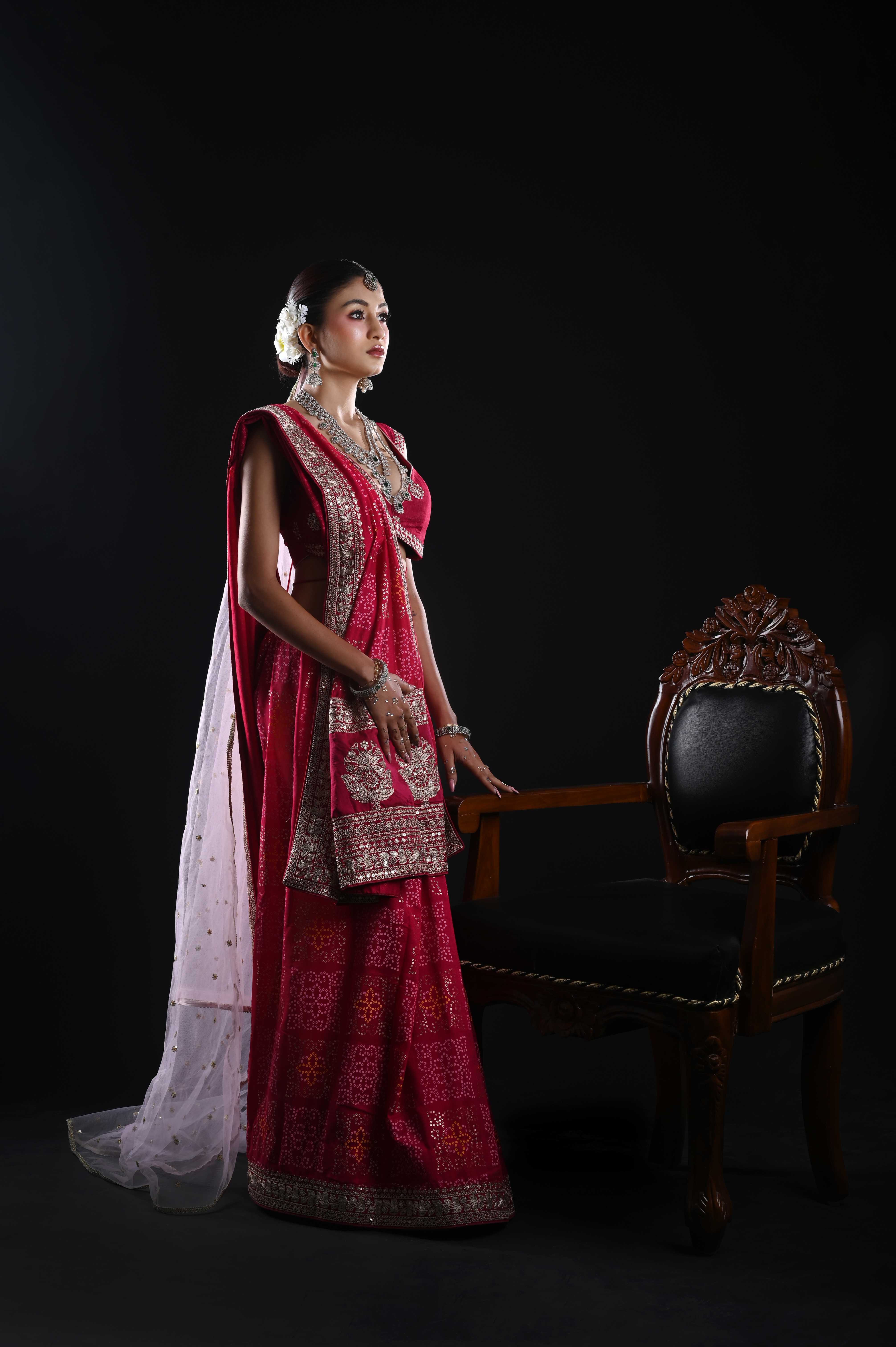Bride in red framed within an architectural setting